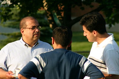 Dr. Raafat Mansour talking to two other attendees at BBQ 2005