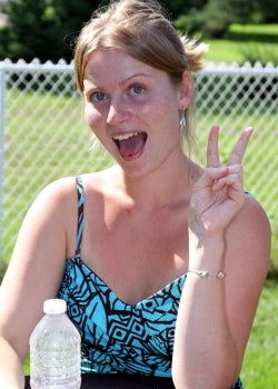 A female attendee giving a peace sign at BBQ 2010