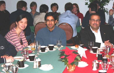 Two attendees with Dr. Raafat Mansour at Christmas lunch 2003