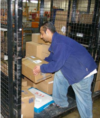 Man loading boxes into a moveable cage