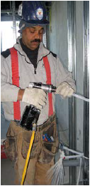 Worker operating a power tool
