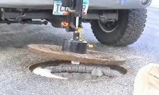 Lifting hole cover using truck mounted magnetic hole cover lifter