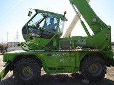 A person operating loader with modified cabin that tilts