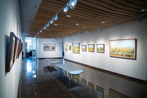 a view of the Grebel Gallery with framed paintings on opposite walls