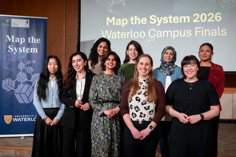 group of people smiling on stage 