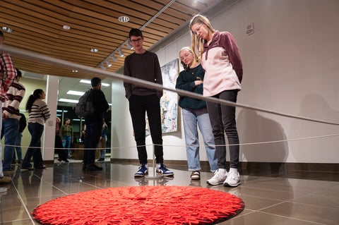 People standing around art