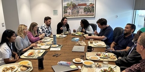 ten people laughing and having lunch 