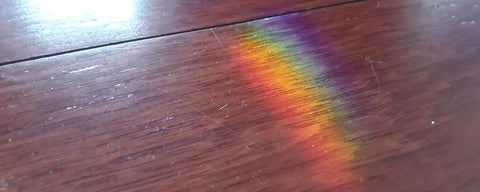 Rainbow shining on hardwood floor