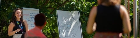 Katie facilitating outside with a flip chart