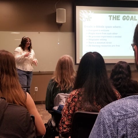 Peace innovator explaining her debate initiative