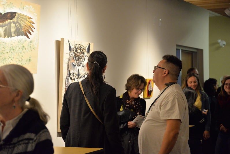Guests admiring the piece "Deer Mouse is Honoured" 