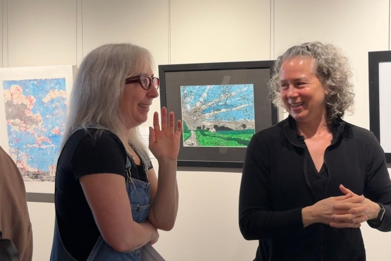 Nina speaking to a friend at the artist event