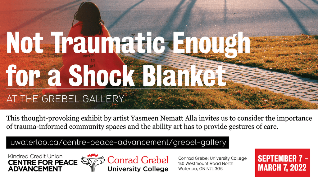 Not Traumatic Enough for a Shock Blanket poster depicting a brunette woman wrapped in a blanket and looking into the horizon.
