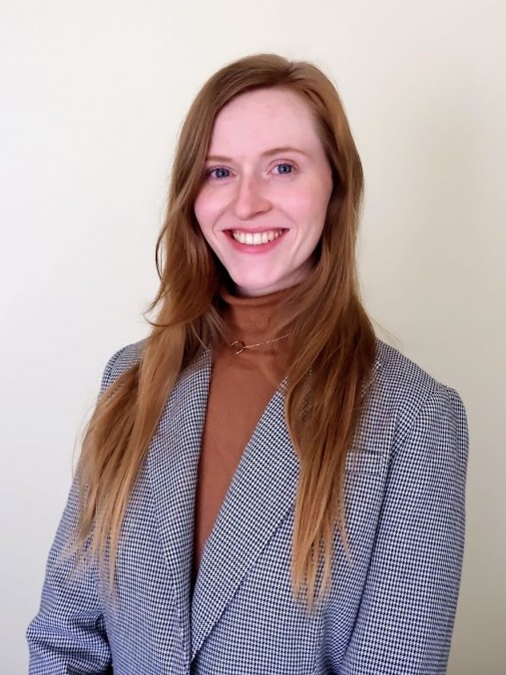 Katie Fry wearing a blazer and turtleneck