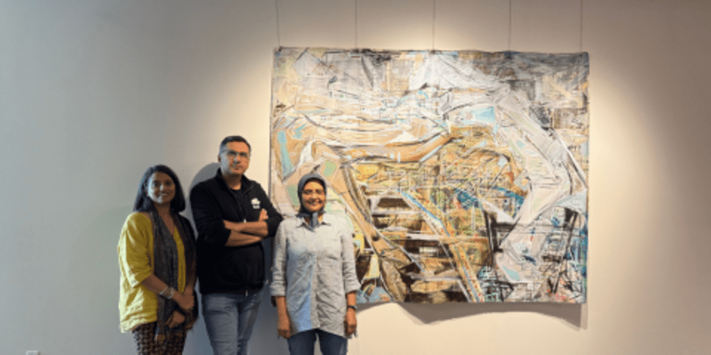 Artists standing infront of art