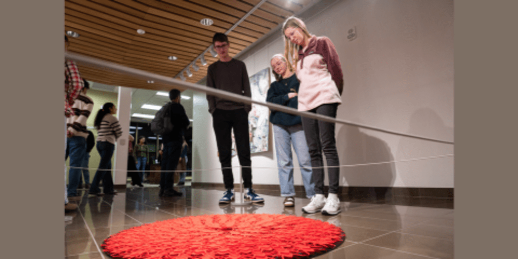 People standing around art