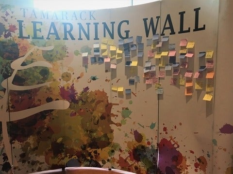 The Learning Wall - attendees placed sticky notes with what they learned from the workshop on a wall together