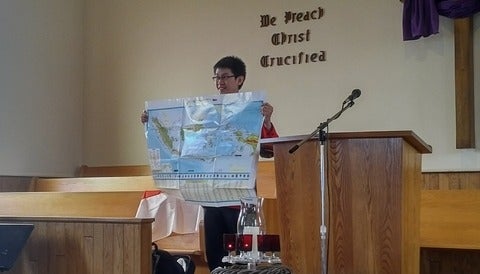 Current CPA IVEP participant Lorenzo Fellycyano presenting in front of a Mennonite Congregation