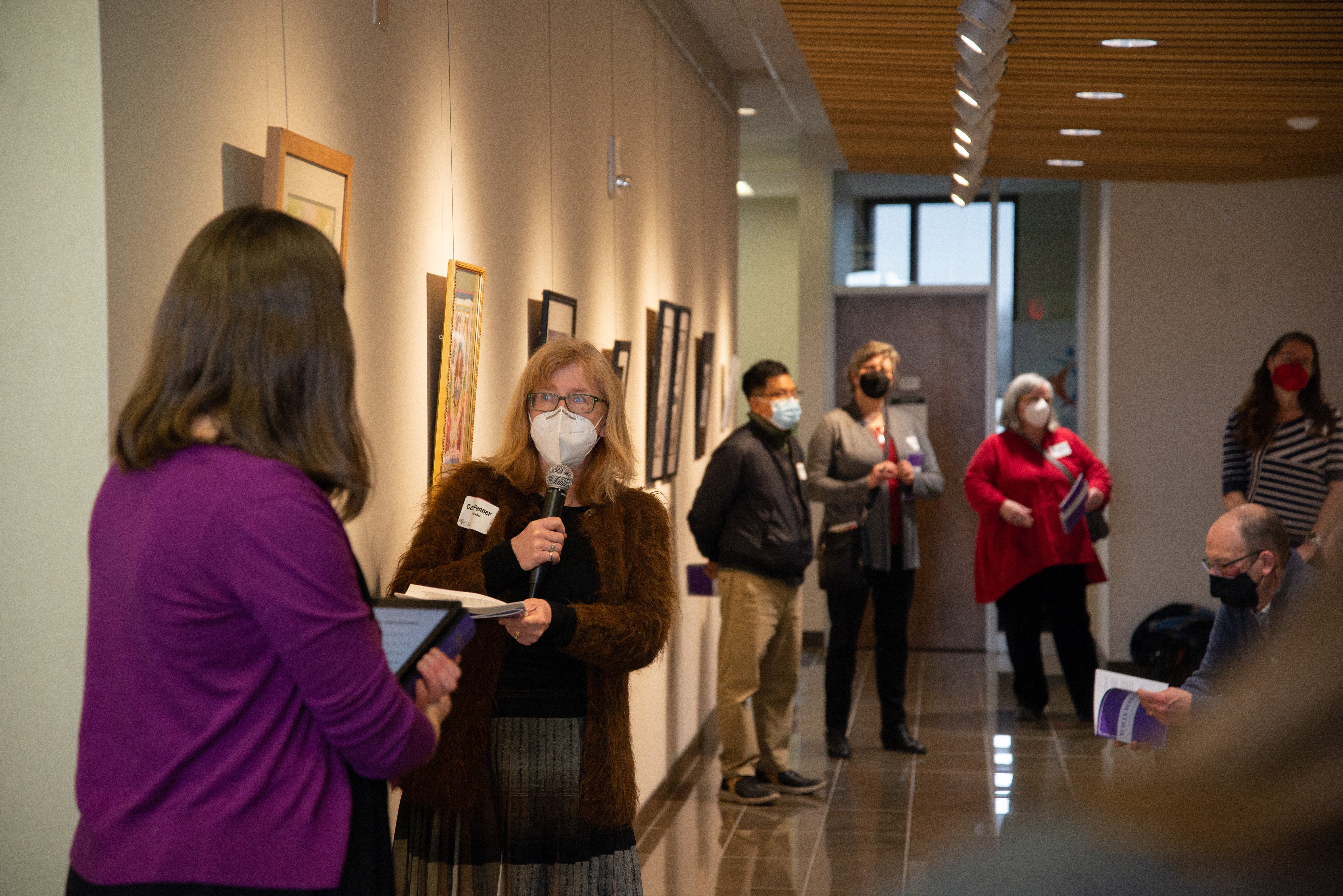 Carol Penner speaking to artist in Grebel Gallery