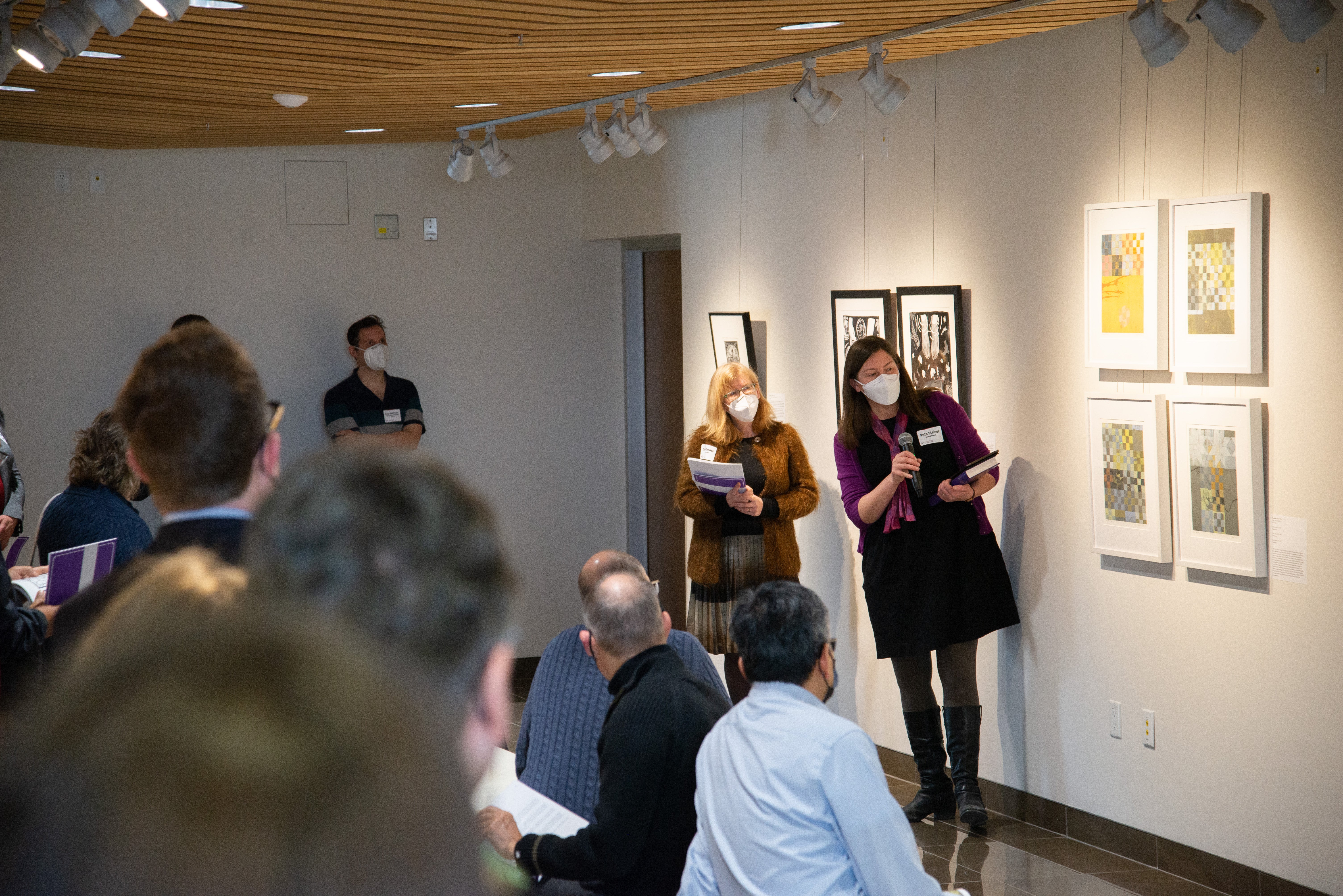 Kate Steiner pointing at art exhibit in Grebel Gallery