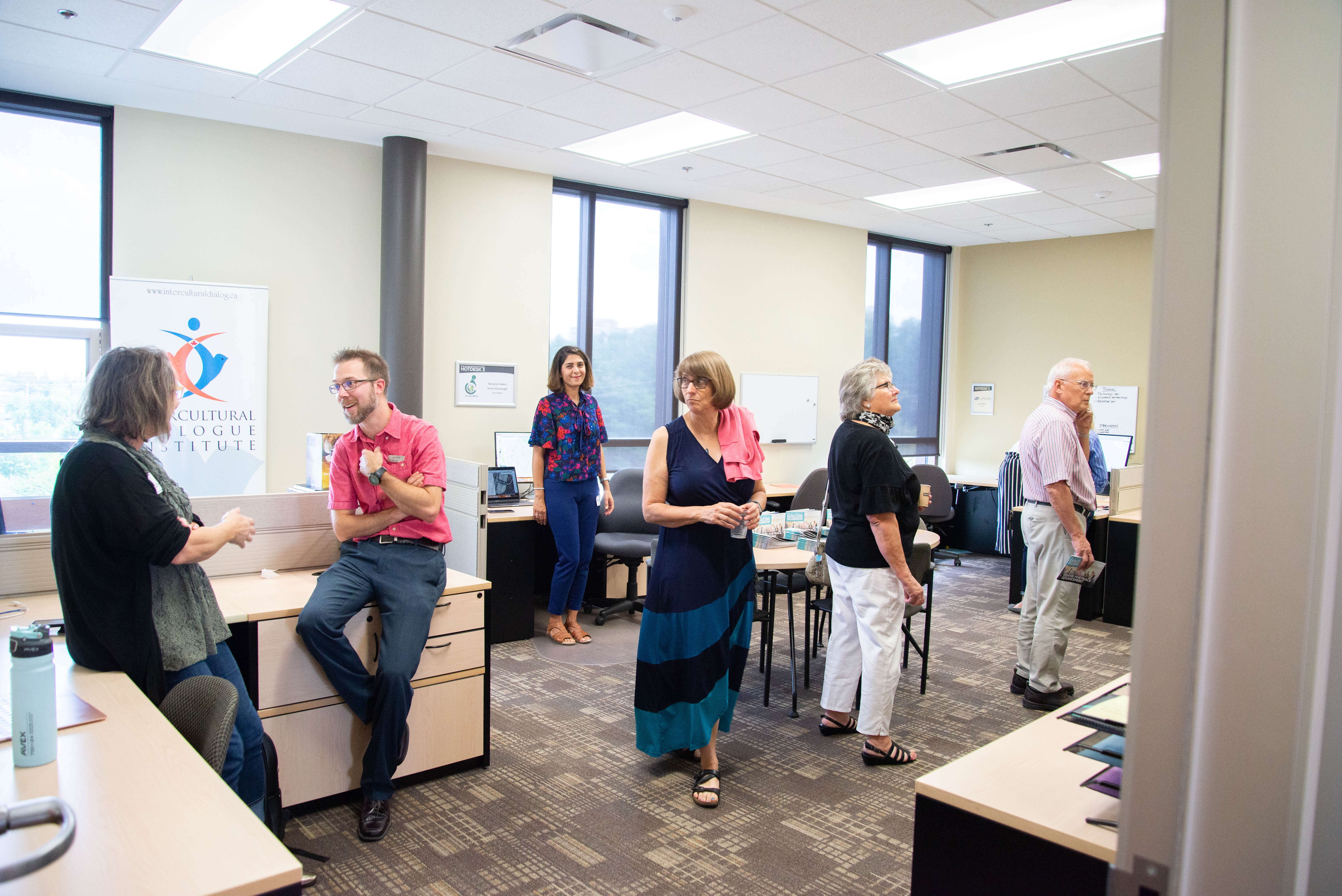 The Grebel Peace Incubator room with a group of people visiting and chatting