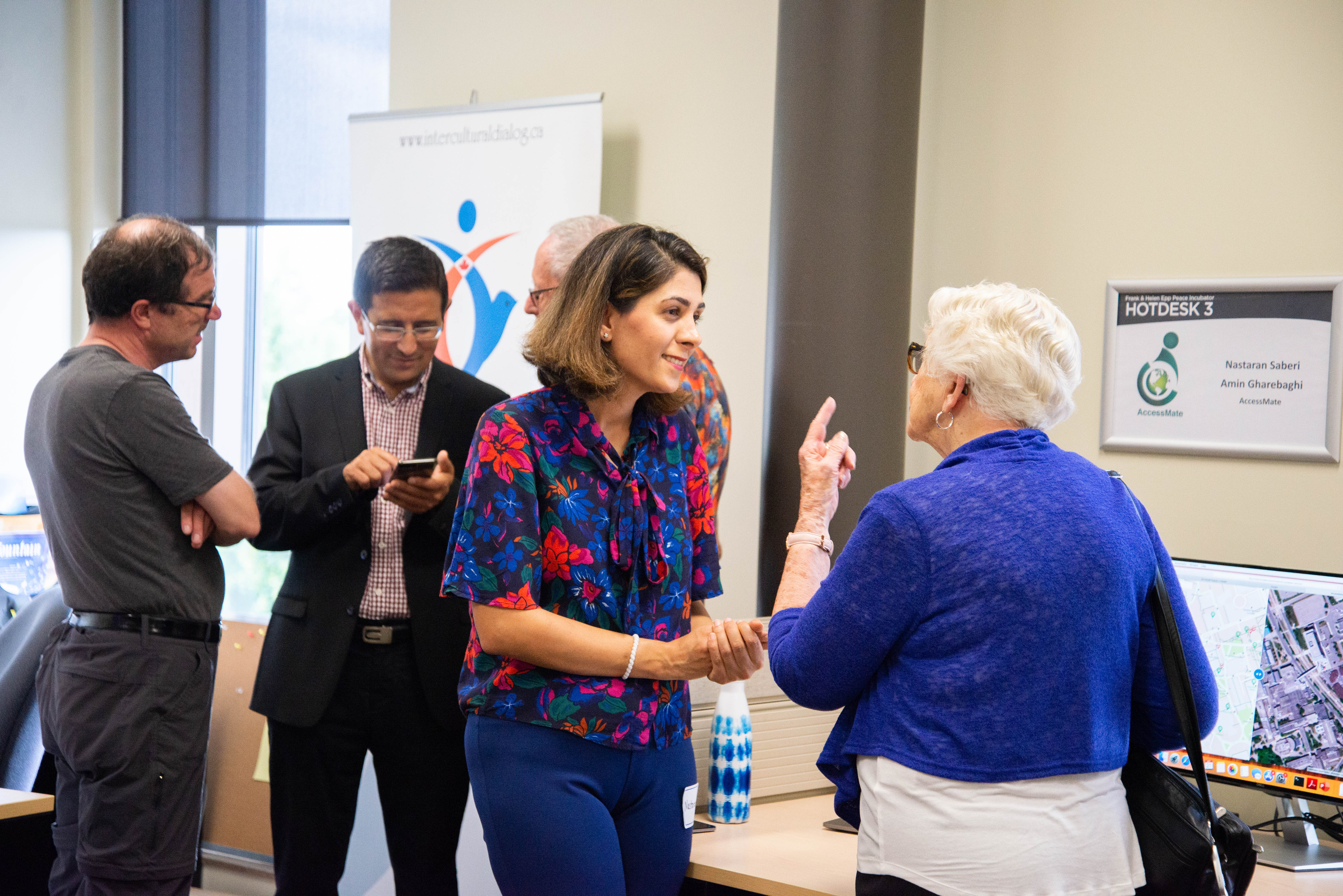 A group of visitors talking in the Grebel Peace Incubator room