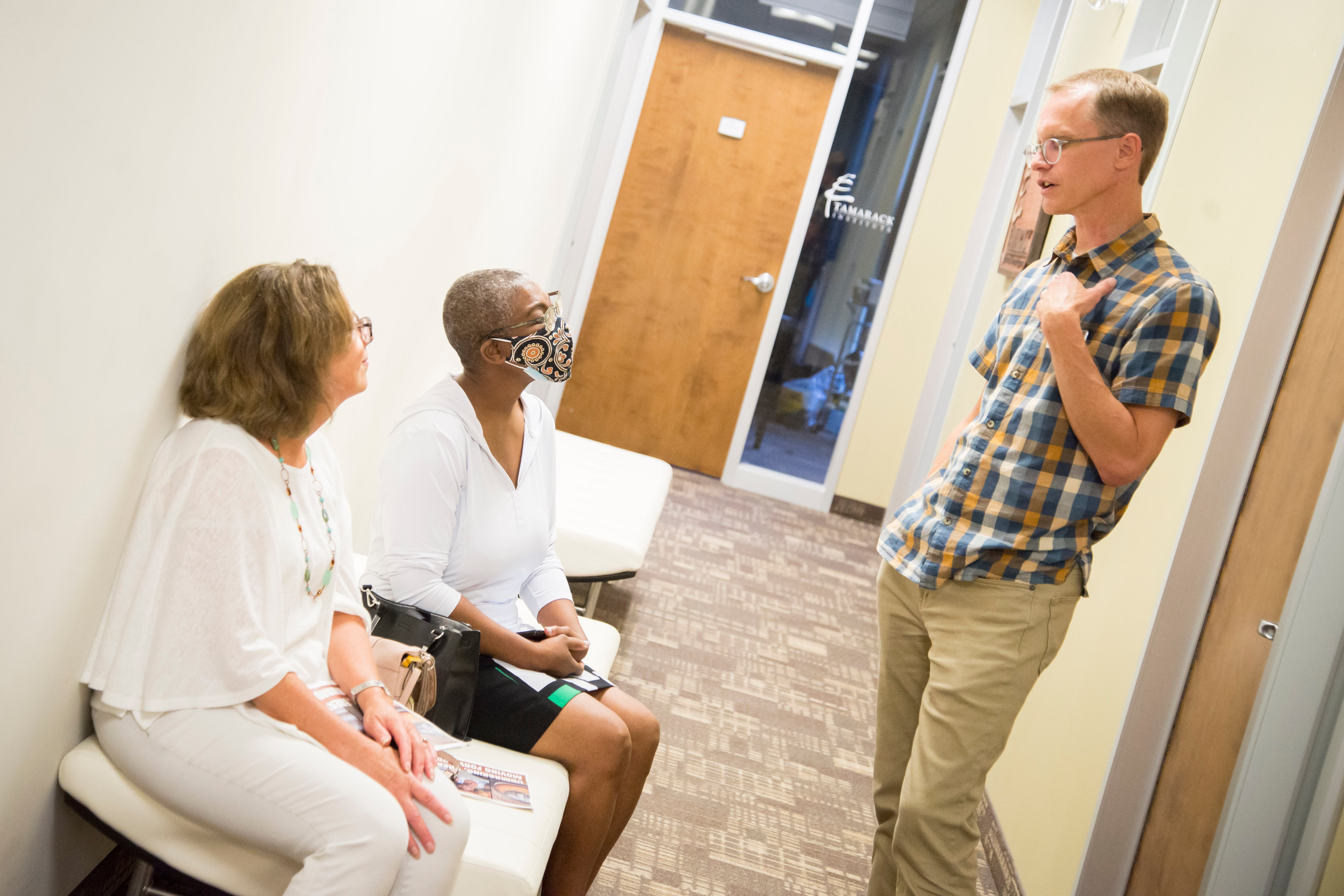 Paul Heidebrecht speaking with two people in the CPA