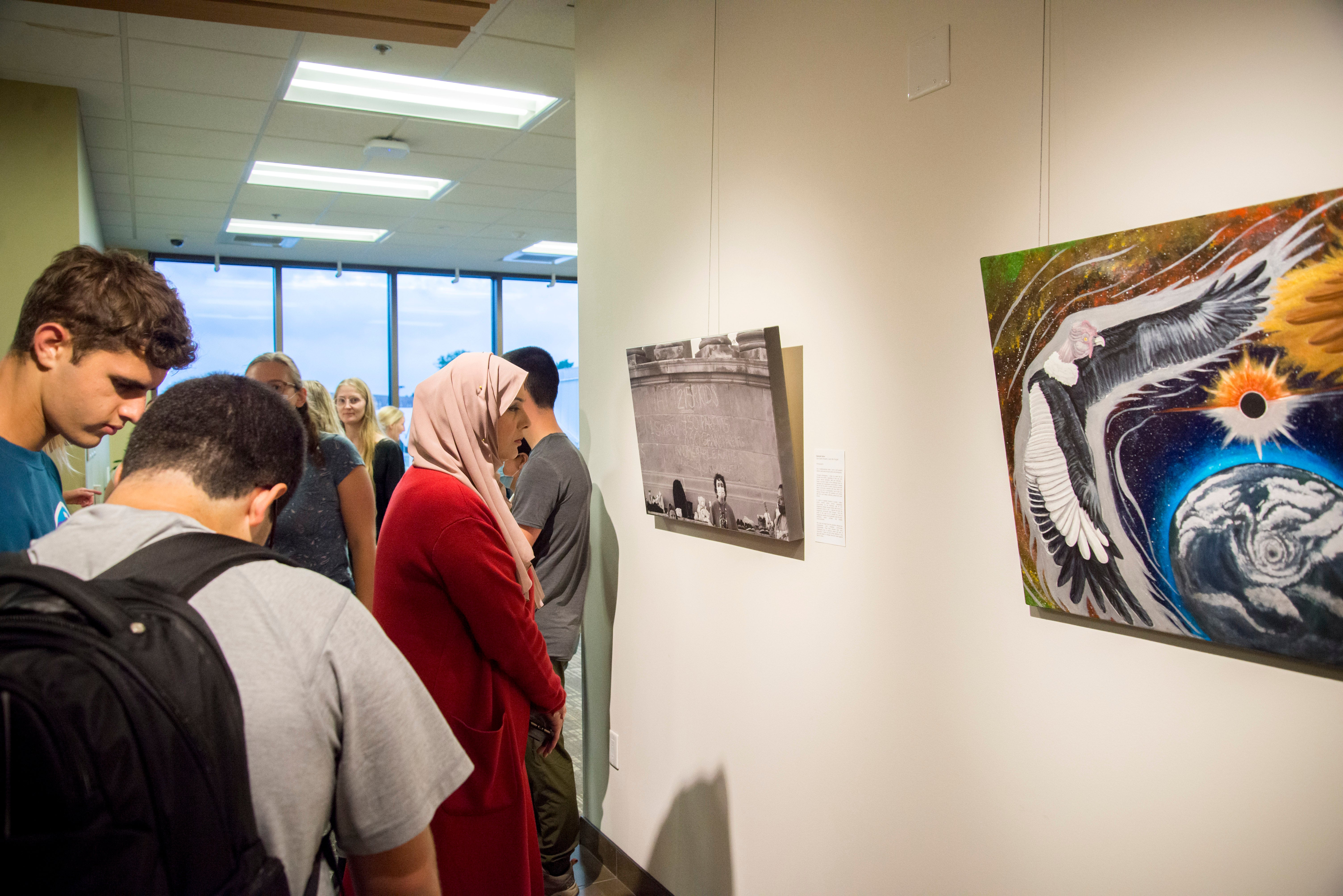 A group of students looking at pictures in the Grebel Gallery