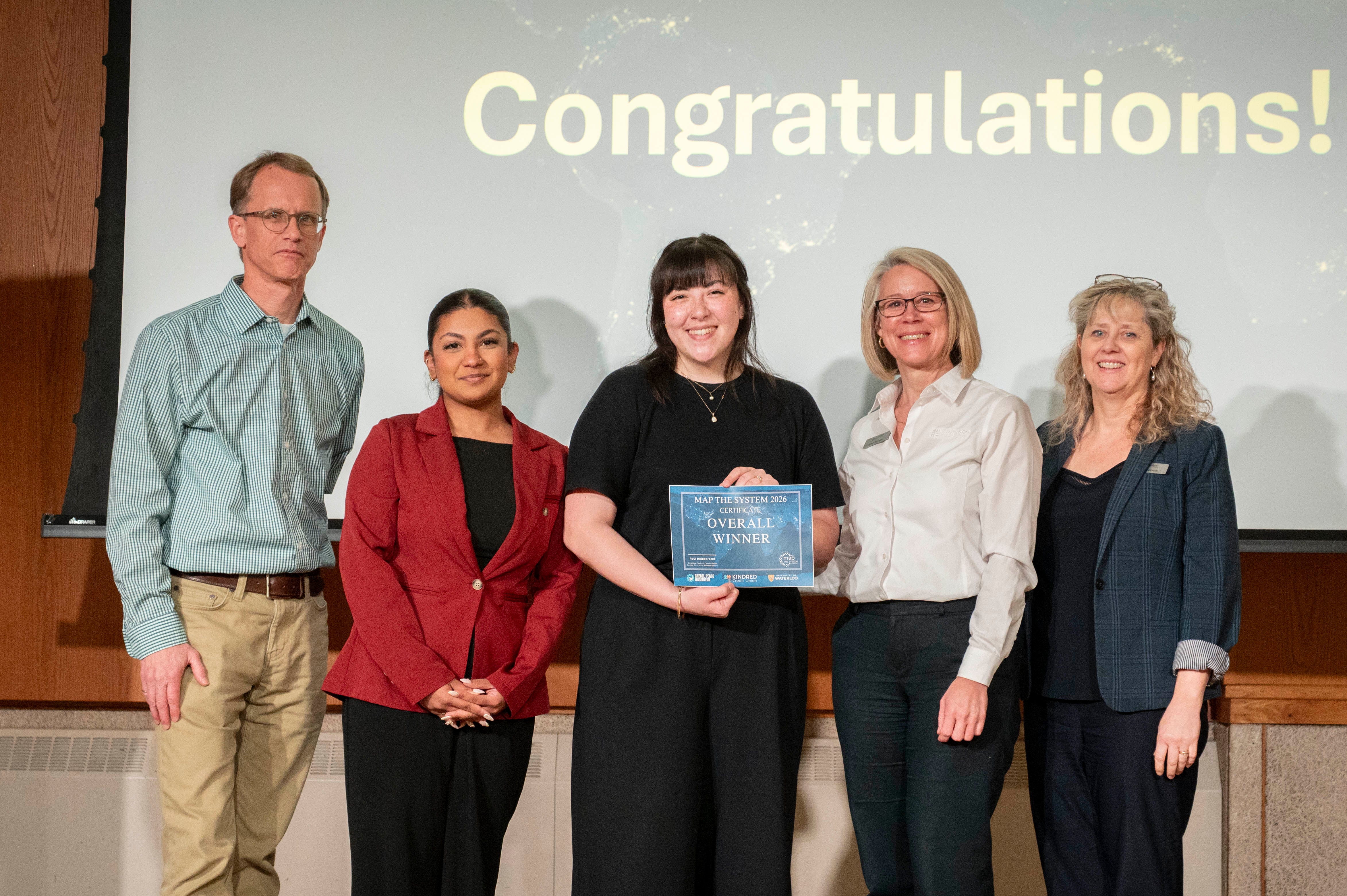 small group with a woman holding a certificate 