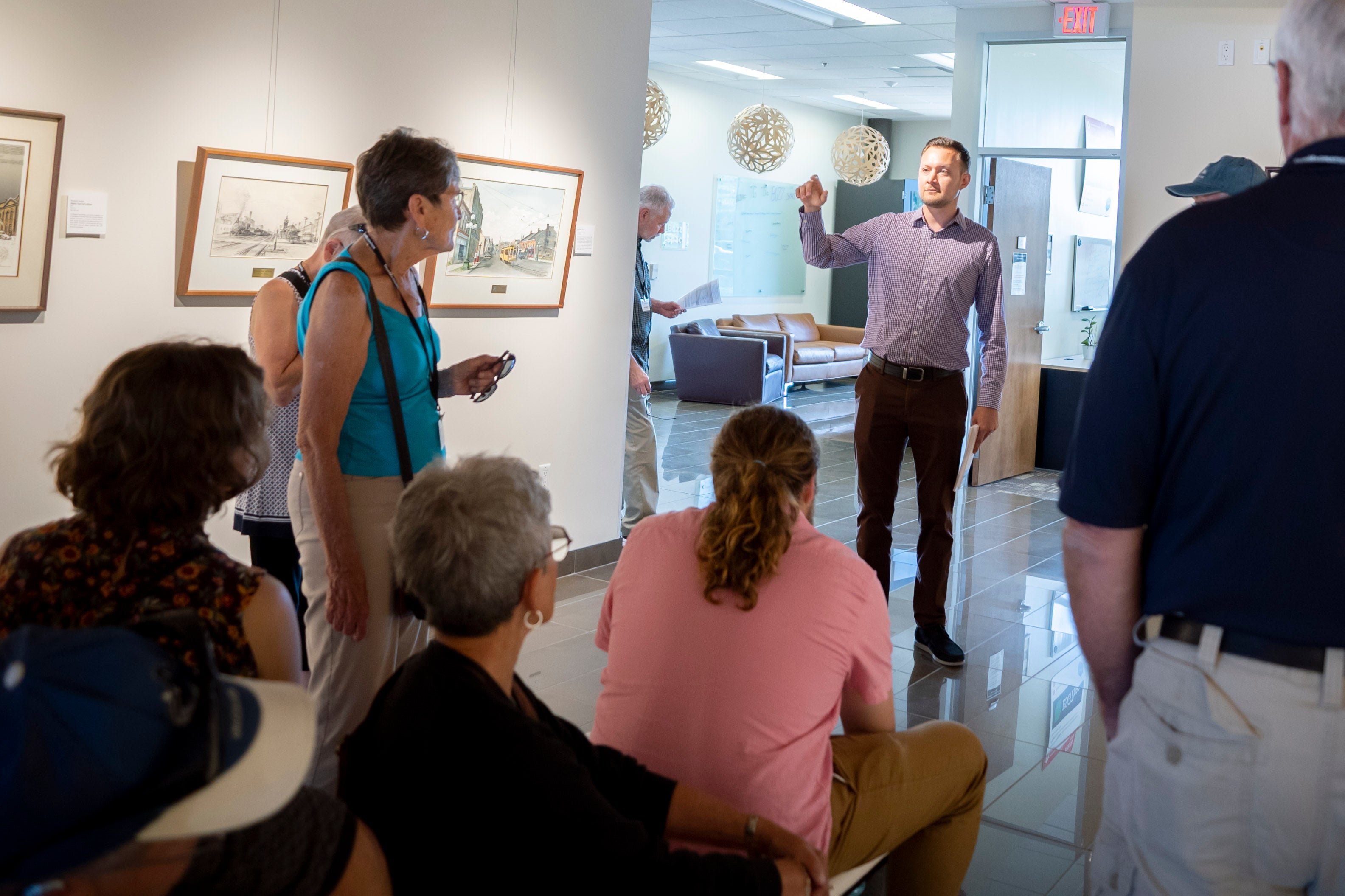 David Neufeld speaks to a tour group in the Grebel Gallery