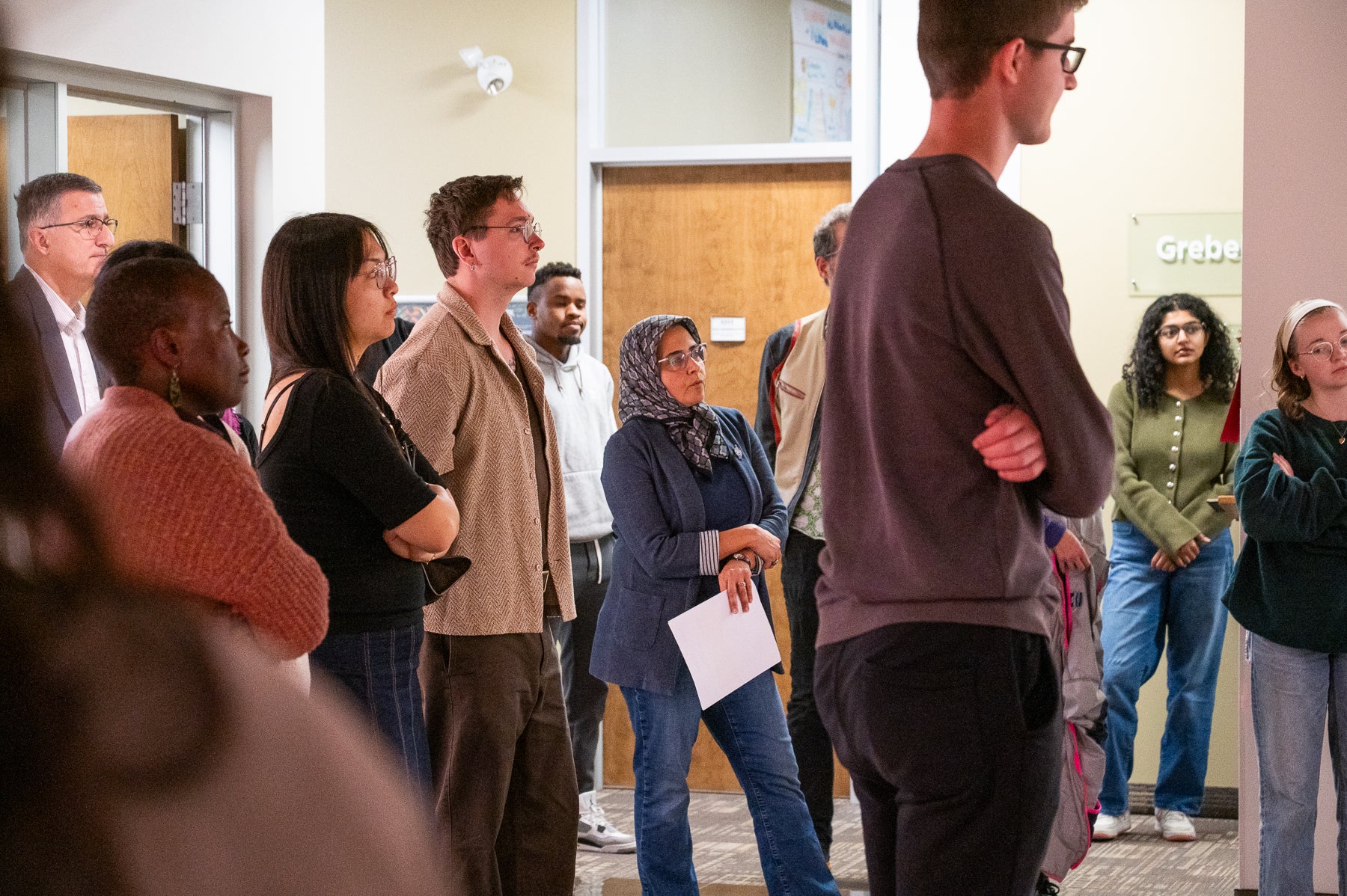 a large group of people looking in the direction of a speaker