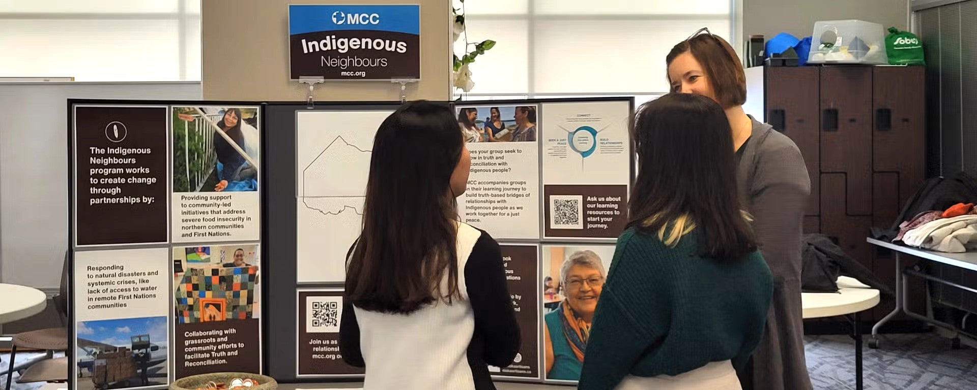 woman presenting to two girls