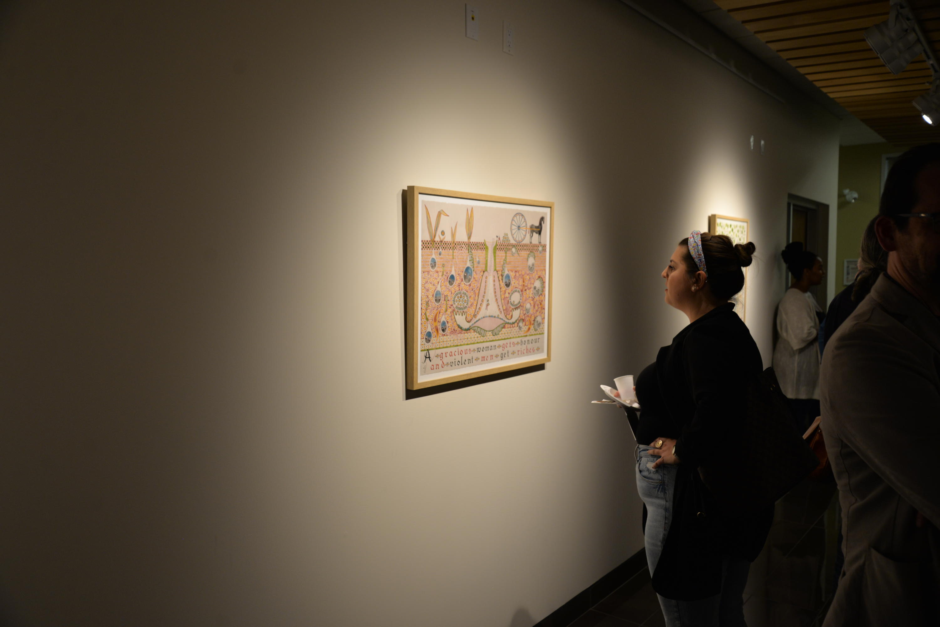 A woman looking at the art work