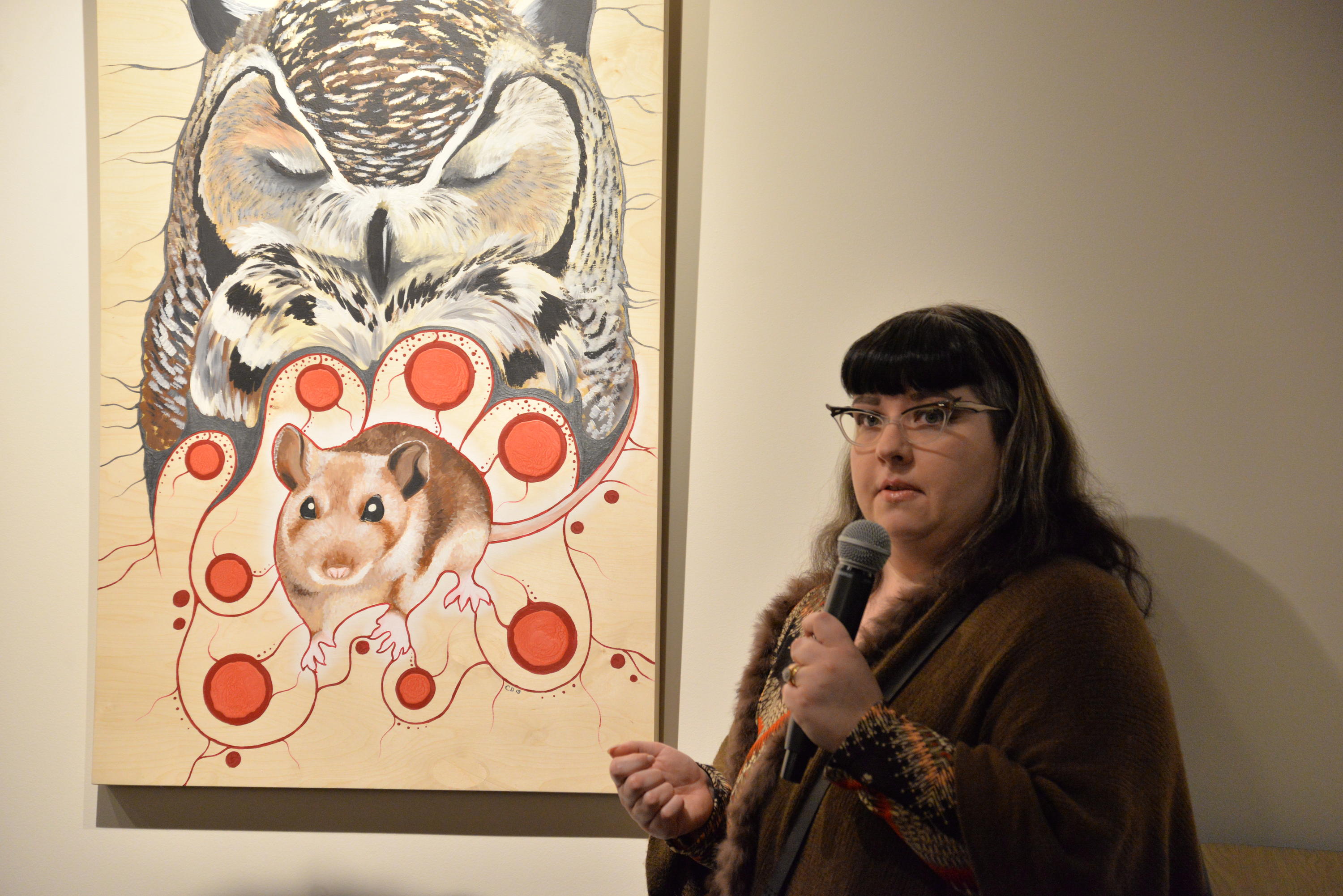 Artist Catherine Dallaire stands beside her painting