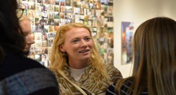 Students talking at the exhibit receptioin