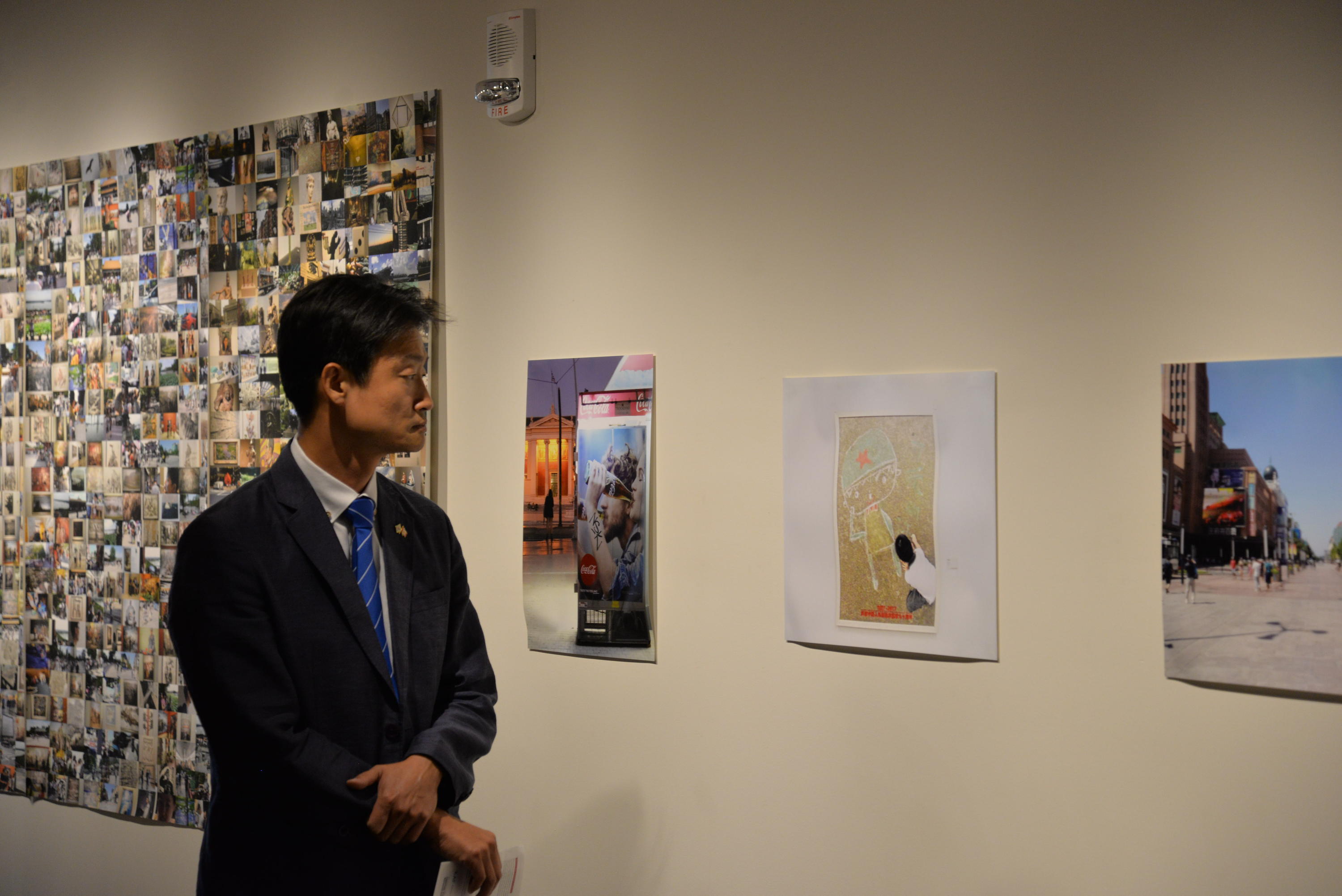 Exhibit guest looking at gallery artwork