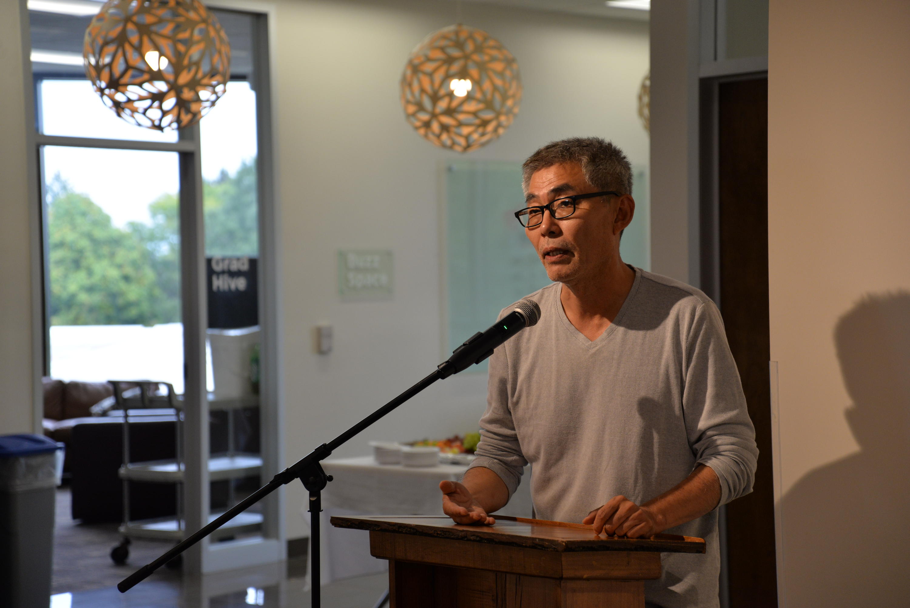 Heng-Gil Han speaking to exhibit reception guests