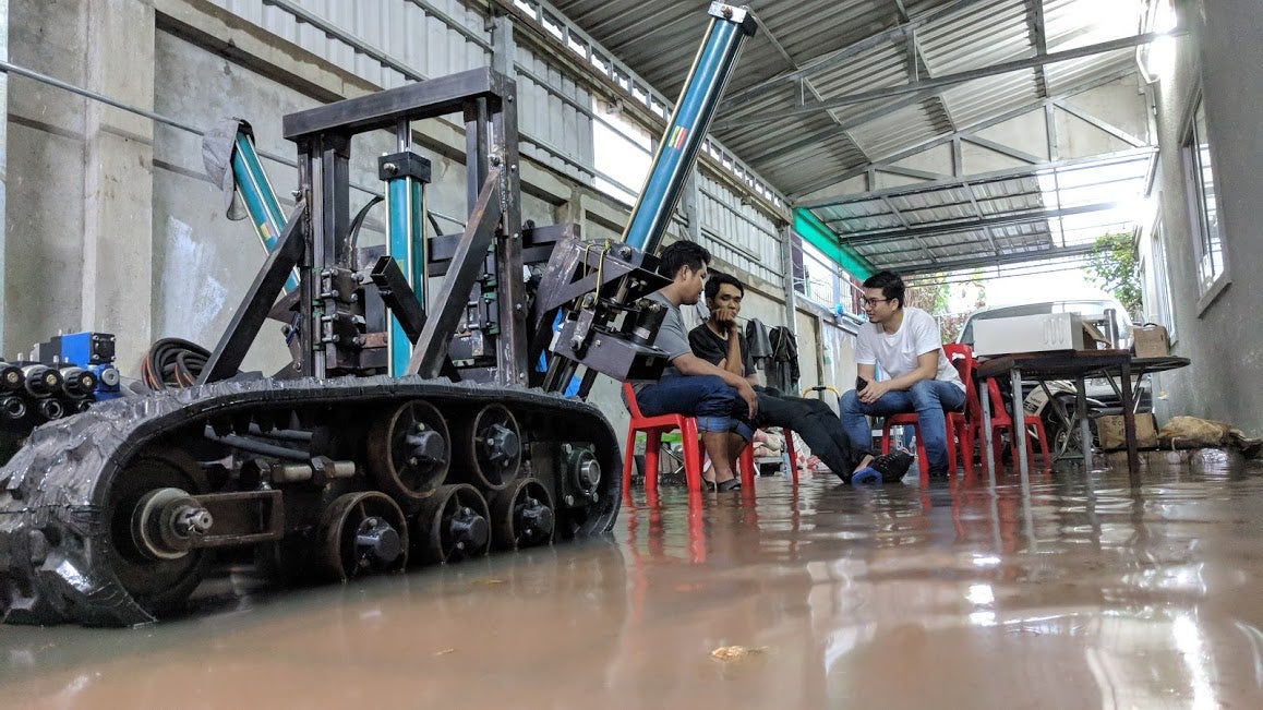 Richard Yim and Demine Robotics team with robot prototype