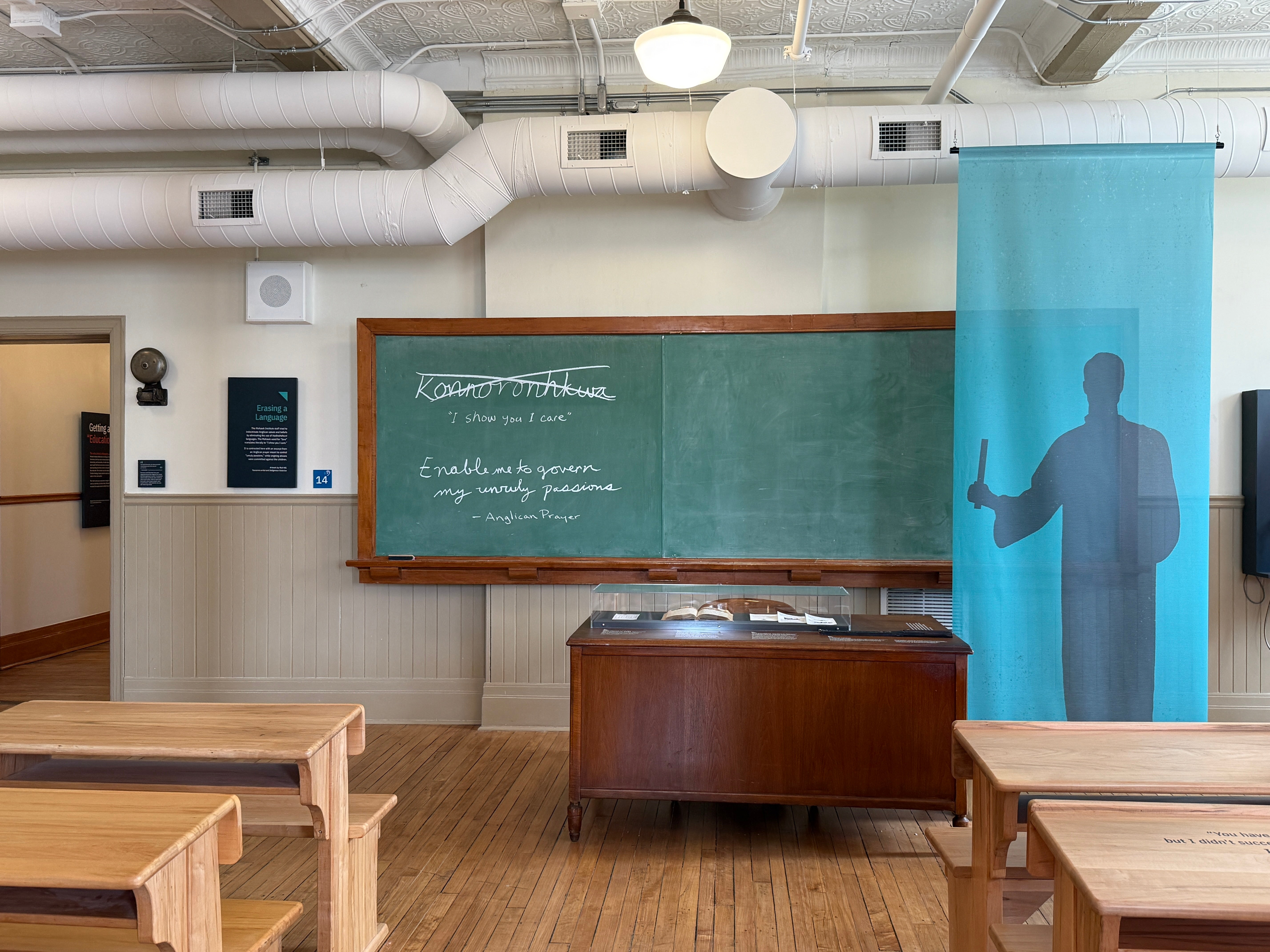 desks facing a chalkboard and desk