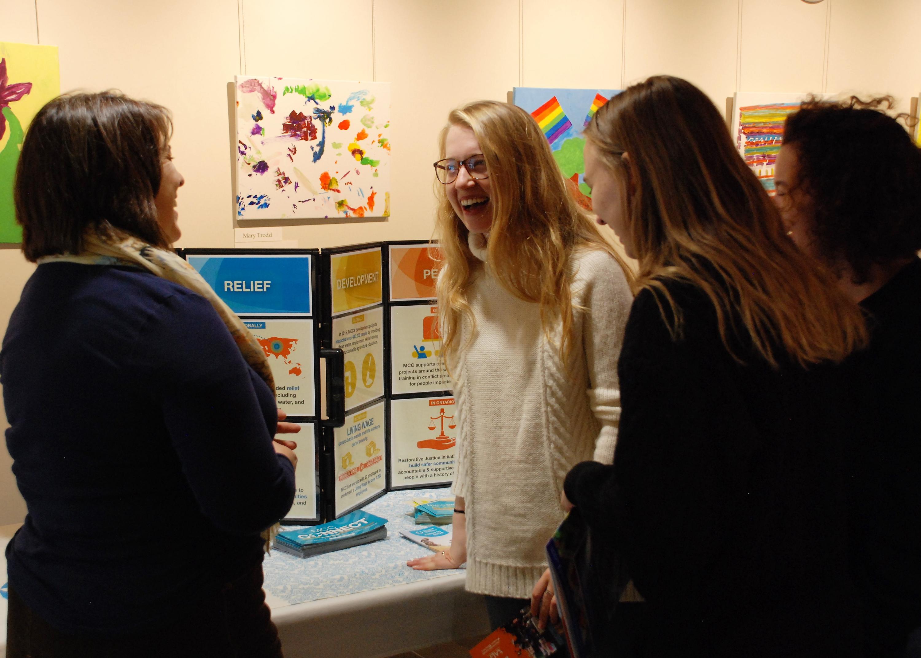 Students speaking with Core Collaborator representative at the Opportunities Fair