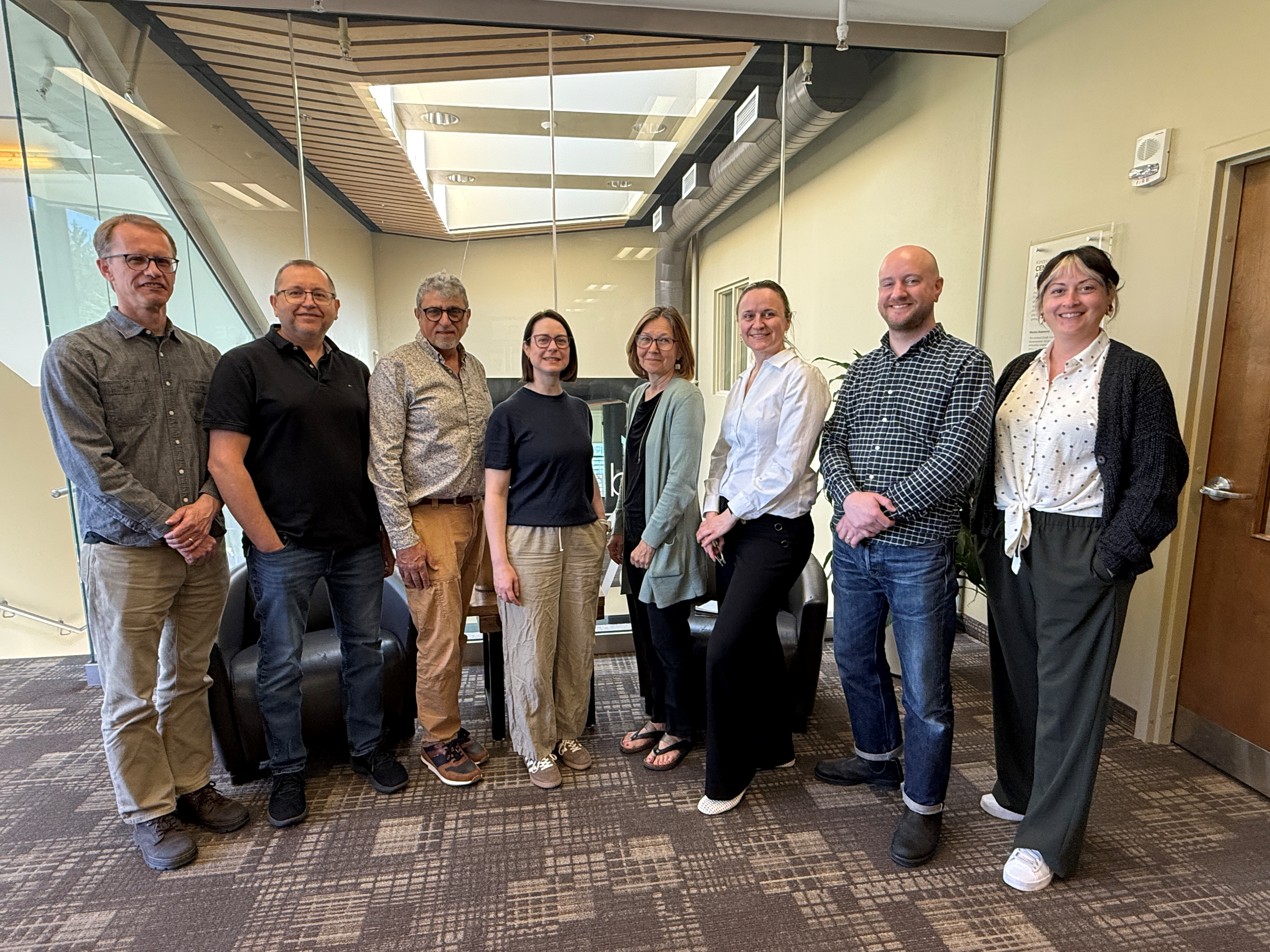 Ploughshares staff Paul, Matthew, Fred, Jessica, Lynne, Branka, Kelsey, and Lisa pose in front of the Centre for Peace Advancement