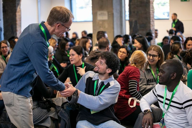 paul shaking hands with a guy