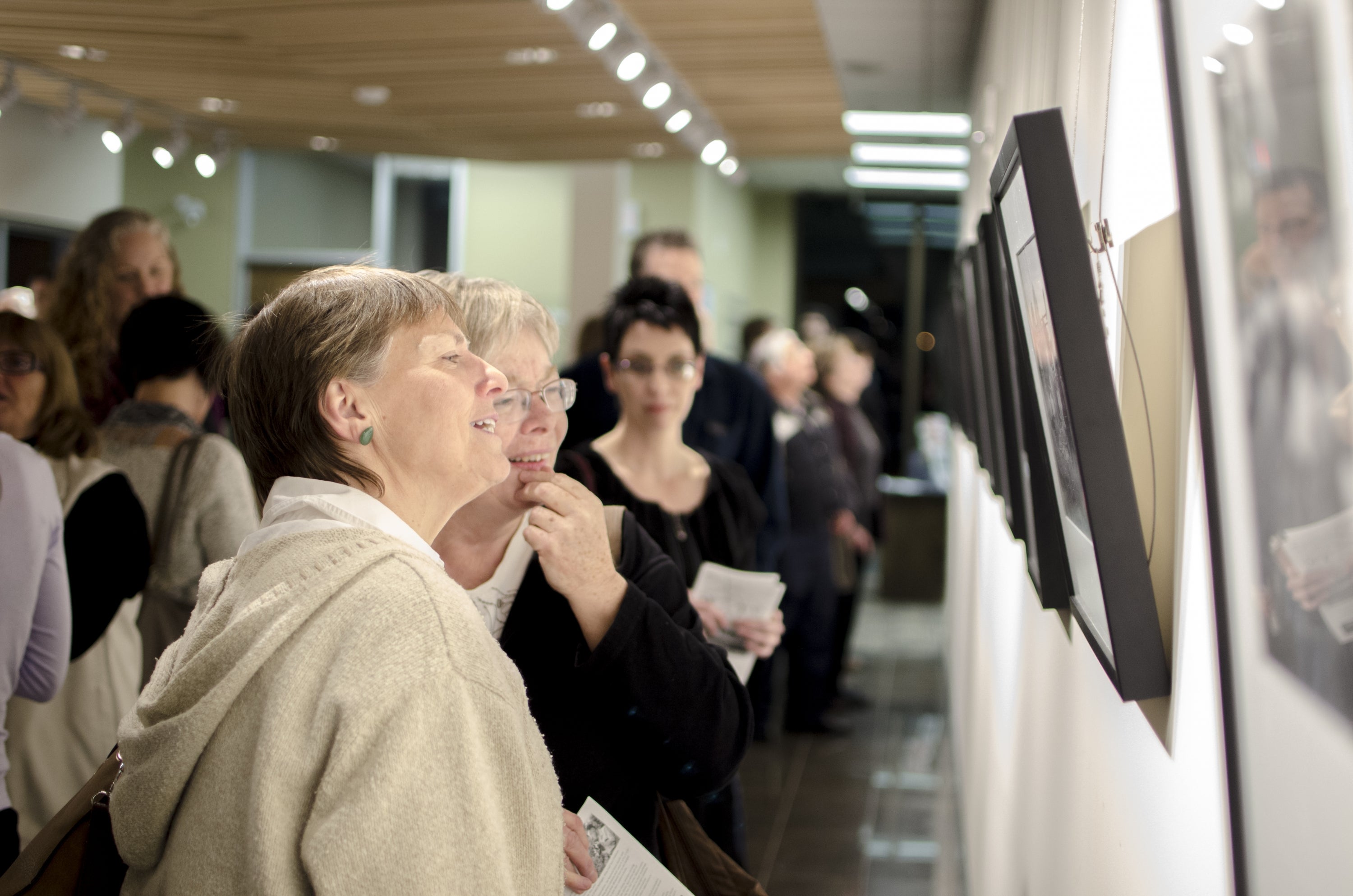 women admiring a photo in the Grebel Gallery