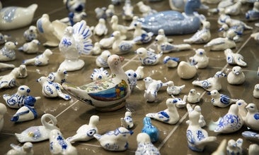 A group of small, blue and white porcelan birds on the Grebel Gallery tiled floor