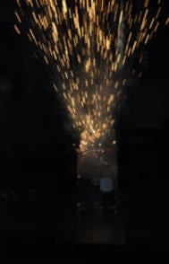  a burst of flames coming out of a beaker with clear and colourless solution in a darken 