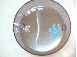 White and blue crystals on two sides of circle, which white line in the middle.