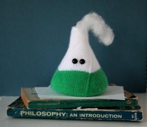 Plushie Erlenmeyer flask on top of two books.