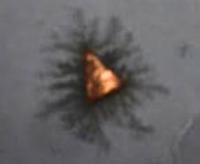littlest chemistree of made of a triangle of copper with black colour branches upclose under a microscope 