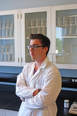 Kevin Potoczny standing in a laboratory