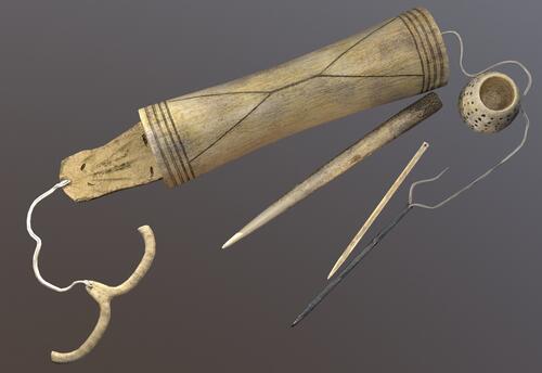 Inuit bone needles and walrus tusk case.